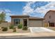 Charming single-story home featuring a well-maintained front yard with desert landscaping and an attached garage at 1630 E Prickly Pear Pl, Casa Grande, AZ 85122