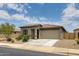 Charming single-story home featuring a well-maintained front yard with desert landscaping and an attached garage at 1630 E Prickly Pear Pl, Casa Grande, AZ 85122