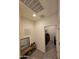 Hallway view with a laundry area on the right and entryway with bench and mirror in the foreground at 1630 E Prickly Pear Pl, Casa Grande, AZ 85122