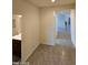 Hallway view with tile flooring, connecting to a bathroom and offering a glimpse of the home's layout at 1630 E Prickly Pear Pl, Casa Grande, AZ 85122