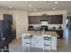 Spacious kitchen featuring dark cabinets, stainless steel appliances, granite countertops, and a large kitchen island at 1630 E Prickly Pear Pl, Casa Grande, AZ 85122