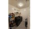 Functional laundry room with modern washer and dryer, complemented by overhead shelving for storage at 1630 E Prickly Pear Pl, Casa Grande, AZ 85122