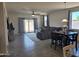Open-concept living room featuring plenty of natural light and tile flooring, seamlessly connecting dining and living spaces at 1630 E Prickly Pear Pl, Casa Grande, AZ 85122