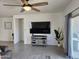 Living room featuring an entertainment center with a wall-mounted TV and plenty of natural light at 1630 E Prickly Pear Pl, Casa Grande, AZ 85122