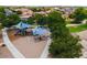 Community playground area featuring modern play structures, shade covers, and a safe, sandy play surface for children at 1630 E Prickly Pear Pl, Casa Grande, AZ 85122