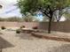 Spacious backyard with gravel landscaping, brick accents, mature trees, and a private walled perimeter at 16526 W Calle Lejos --, Surprise, AZ 85387