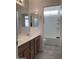 Bright bathroom features a double sink vanity, mirrors, and a separate shower and toilet area at 16526 W Calle Lejos --, Surprise, AZ 85387