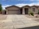 Charming single-story home featuring a well-manicured front yard and attached two-car garage at 16526 W Calle Lejos --, Surprise, AZ 85387