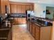 Kitchen features stainless steel appliances, breakfast bar, granite countertops, stylish mosaic tile backsplash and tile flooring at 16526 W Calle Lejos --, Surprise, AZ 85387