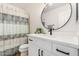 Updated bathroom features quartz countertop, black fixtures, shower with stylish curtain and decor at 16827 S 20Th Way, Phoenix, AZ 85048