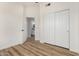 Bright bedroom features hardwood floors, closet, and entry to bathroom at 16827 S 20Th Way, Phoenix, AZ 85048