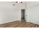 Bright bedroom features hardwood floors, ceiling fan, closet, and entry to another room at 16827 S 20Th Way, Phoenix, AZ 85048