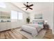 Bright bedroom with a vaulted ceiling, ceiling fan, and large windows overlooking the backyard at 16827 S 20Th Way, Phoenix, AZ 85048