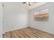 This bedroom features wood floors, a bright window, and neutral paint at 16827 S 20Th Way, Phoenix, AZ 85048