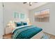 Charming bedroom features white furniture, teal accents, ceiling fan and bright window at 16827 S 20Th Way, Phoenix, AZ 85048