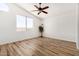 Bright bedroom features vaulted ceiling, large window, and wood-look flooring for a modern touch at 16827 S 20Th Way, Phoenix, AZ 85048