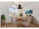 Dining room filled with natural light with a wooden table and chairs at 16827 S 20Th Way, Phoenix, AZ 85048