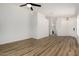 Spacious living room featuring wood flooring and a ceiling fan, bathed in natural light at 16827 S 20Th Way, Phoenix, AZ 85048