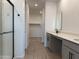 Modern bathroom with double vanity, walk-in shower and walk-in closet at 18243 W La Senda Dr, Surprise, AZ 85387
