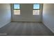 Carpeted bedroom with two windows at 18243 W La Senda Dr, Surprise, AZ 85387
