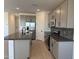 A well-equipped kitchen featuring stainless steel appliances, an island, and ample storage at 18243 W La Senda Dr, Surprise, AZ 85387