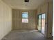 Interior of a bare living room with concrete floor, window, and sliding glass door at 18260 W Camino De Oro --, Surprise, AZ 85387