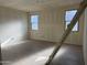 Bright bedroom featuring tile flooring, two large windows, and ample space for furnishings at 18261 W Camino De Oro --, Surprise, AZ 85387