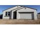 Charming single-story home with a white exterior, complemented by a two car garage at 18261 W Camino De Oro --, Surprise, AZ 85387