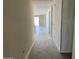 Spacious hallway showcasing new flooring and ample natural light from the sliding glass doors at the end at 18261 W Camino De Oro --, Surprise, AZ 85387