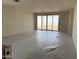 Bright living room featuring sliding glass doors leading to the outdoors with protective plastic on the floor at 18261 W Camino De Oro --, Surprise, AZ 85387