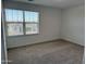 Cozy bedroom features plush carpeting and a large window to let in natural light at 18265 W La Senda Dr, Surprise, AZ 85387