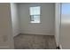 Cozy bedroom with neutral carpet, white walls, and a window with blinds at 18265 W La Senda Dr, Surprise, AZ 85387