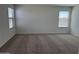 Bright bedroom featuring neutral carpet and abundant natural light from multiple windows at 18265 W La Senda Dr, Surprise, AZ 85387