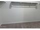 Walk-in closet featuring neutral carpet, white walls, and rod for hanging clothes at 18265 W La Senda Dr, Surprise, AZ 85387