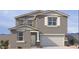 Charming two-story home with a two-car garage, stucco facade, and professionally landscaped front yard at 18265 W La Senda Dr, Surprise, AZ 85387
