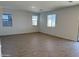 Bright living room featuring ceramic wood-look tiling and neutral paint at 18265 W La Senda Dr, Surprise, AZ 85387