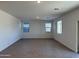 Spacious living room featuring ceramic wood-look tiling and neutral paint at 18265 W La Senda Dr, Surprise, AZ 85387