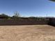 Large backyard ready for landscaping, surrounded by block wall for privacy at 18271 W La Senda Dr, Surprise, AZ 85387