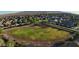 Aerial view of community baseball field surrounded by homes and desert landscape in a Gathering-friendly neighborhood at 18271 W La Senda Dr, Surprise, AZ 85387