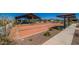 Bocce ball court with shade covering, park benches and desert landscaping in a Gathering friendly community at 18271 W La Senda Dr, Surprise, AZ 85387