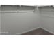 Walk-in closet with carpeted floor and clothes rack at 18271 W La Senda Dr, Surprise, AZ 85387