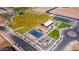 Aerial view of a community park with tennis and basketball courts, playground, green spaces, and walking paths at 18271 W La Senda Dr, Surprise, AZ 85387