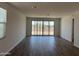 Open living room with hard surface floors and sliding glass doors to backyard at 18271 W La Senda Dr, Surprise, AZ 85387