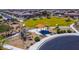 Aerial view showcasing a neighborhood park with a playground, seating, and green space at 18271 W La Senda Dr, Surprise, AZ 85387