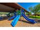 Bright blue slides and playground equipment in a Gathering-friendly community with shady park area at 18271 W La Senda Dr, Surprise, AZ 85387
