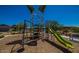 Community playground featuring a slide, climbing structure, and swing for Gathering fun at 18271 W La Senda Dr, Surprise, AZ 85387