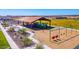 Aerial view of playground with climbing structures, slides and swings in this Gathering-friendly community at 18271 W La Senda Dr, Surprise, AZ 85387