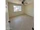 Well-lit bedroom featuring tile flooring and a ceiling fan, providing a comfortable space at 18629 N 4Th Dr, Phoenix, AZ 85027
