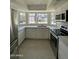 Modern kitchen with stainless steel appliances, white cabinets, quartz countertops, and a bay window at 18629 N 4Th Dr, Phoenix, AZ 85027
