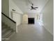 Spacious living room featuring a fireplace, neutral walls, tile flooring, and modern ceiling fan at 18629 N 4Th Dr, Phoenix, AZ 85027